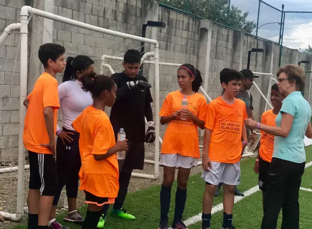 Helena Pacheco and the young players in the #100Women football game in Rio