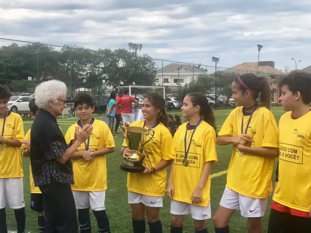 The #100Women trophy being awarded by 93-year old swimmer Nora Ronai