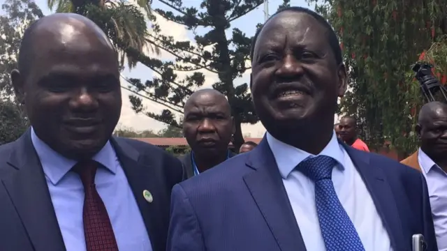 Raila Odinga (R)