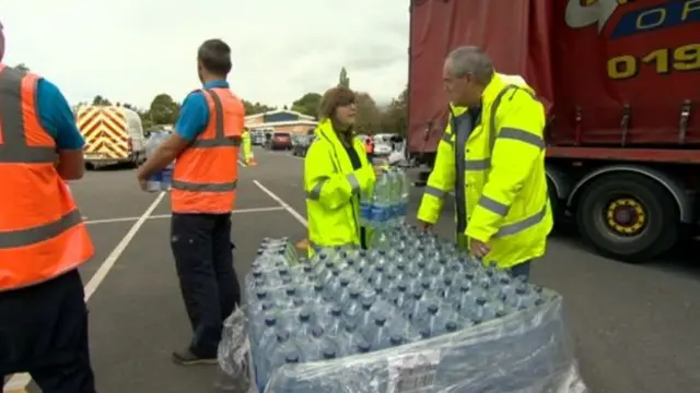 Bottled water being handed out