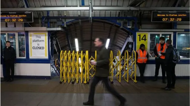 A man walking past a closed railway platform