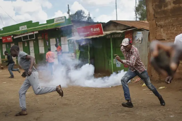 Supporters of the National Super Alliance (Nasa) and its presidential candidate Raila Odinga flee as a tear gas is fired by police to disperse them in Kawangware slum, Nairobi, Kenya, 30 October 2017