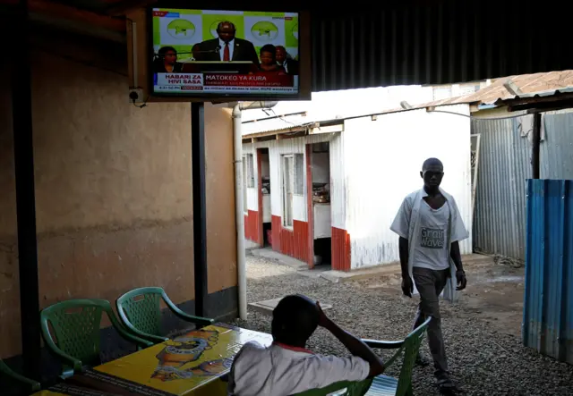 People watch on television the announcement of the winner of polls in Kenya"s repeat presidential election in Kisumu, Kenya October 30, 2017.