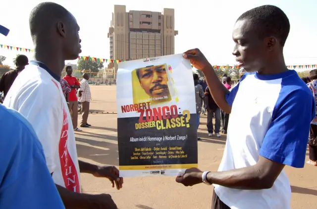 Demonstrators show a poster with a portrait of late journalist Norbert Zongo on December 13, 2008 during a protest in Ouagadougo against the impunity in the case of Burkinabe journalist Norbert Zongo - 2008