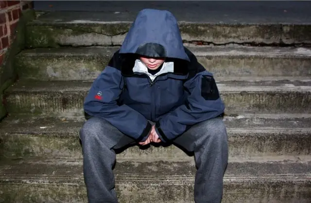 Boy sitting on steps