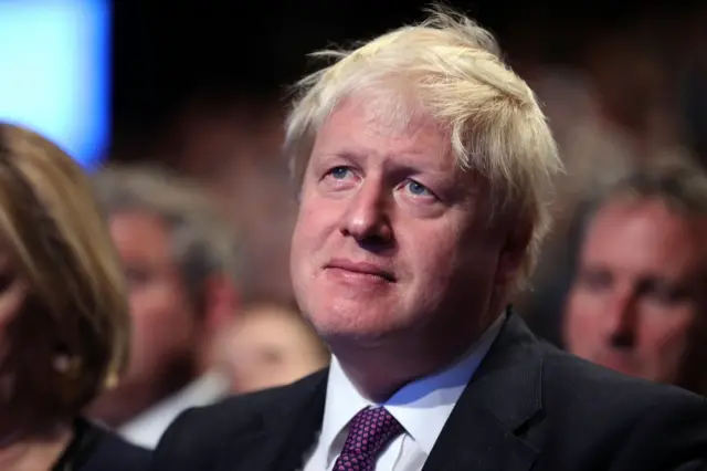 Foreign Secretary Boris Johnson looks on as Prime Minister Theresa May delivers her keynote speech to delegates and party members on the last day of the Conservative Party Conference at Manchester Central on October 4, 2017 in Manchester, England