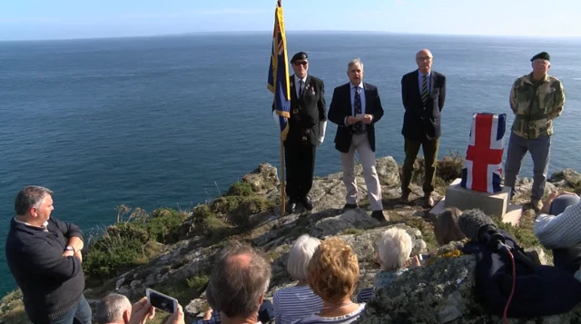 A commemorative stone is unveiled at the site of the raid