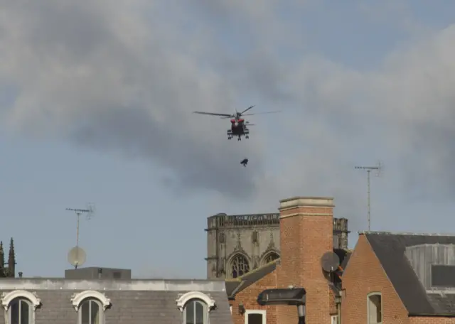 Helicopter airlifting casualty from top of York Minster