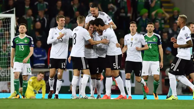 Sebastian Rudy of Germany is mobbed by team mates