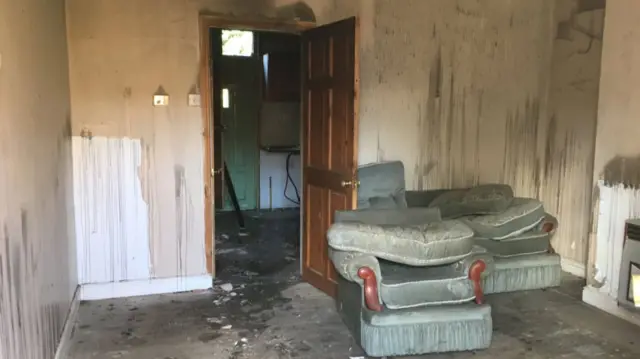 Smoke stained living room of derelict house