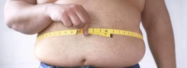 Man measuring stomach