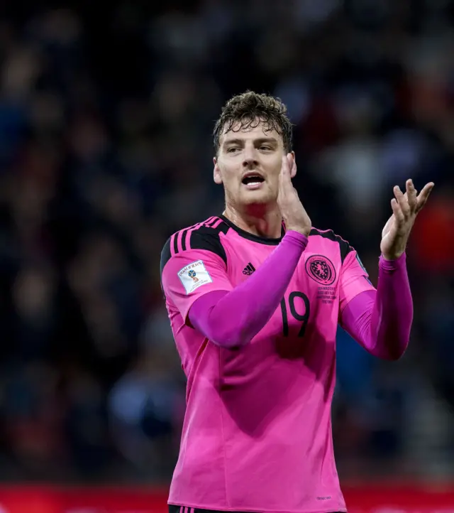 Chris Martin applauds the Scotland fans after beating Slovakia