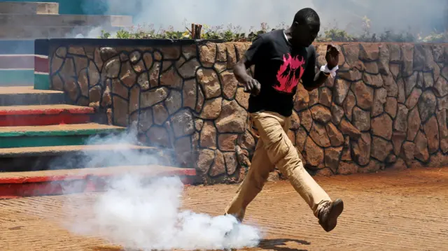 An opposition supporter runs from tear gas fired by policemen during a protest calling for the sacking of election board officials involved in August"s cancelled presidential vote, in Nairobi, Kenya 9 October 2017