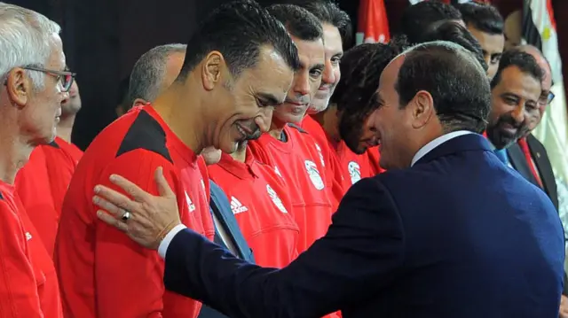 Egypt's President Abdul Fattah al-Sisi shaking hands with Egypt's football national football team