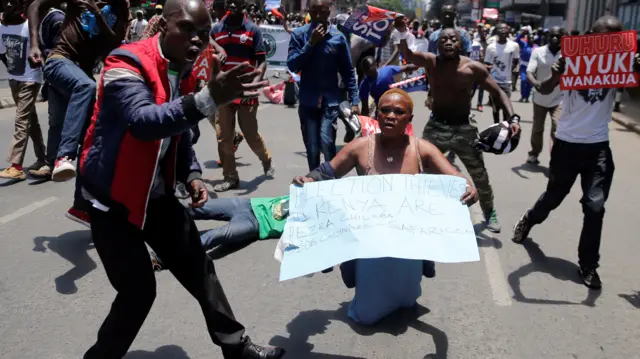 Opposition supporters carry banners during a protest calling for the sacking of election board officials involved in August's cancelled presidential vote, in Nairobi, Kenya