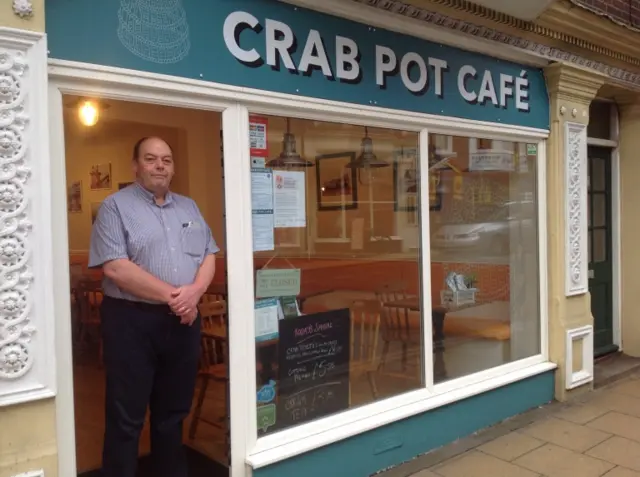 Mike Fuhri stands in open doorway of Crab Pot Cafe