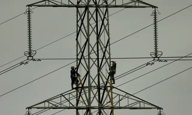 Workers on an electricity pylon