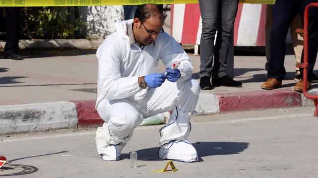 A forensic officer outside the parliament in Tunis, Tunisia