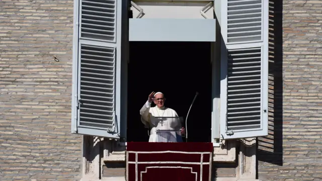 Pope Francis waves after delivering his message to pilgrims gathered in St. Peter's Square at the Vatican on 1 November 2017