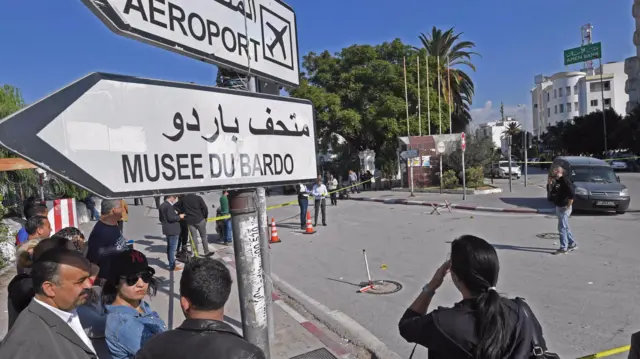 Bystanders outside the parliament in Tunis, Tunisia