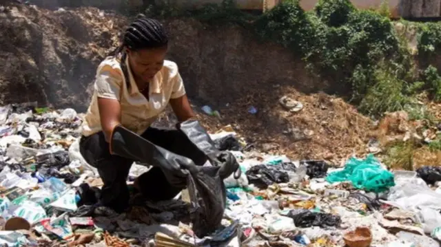 Woman collecting plastic bags