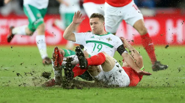 Northern Ireland's Jamie Wards slides into a tackle