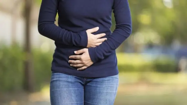 Woman holding tummy