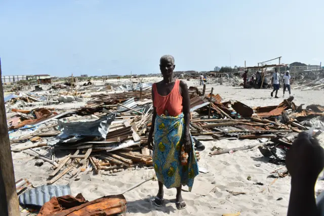 Elizabeth Medjiten, a 79 years old woman stands amidst the rubble of the place where she was born and had lived all her life.