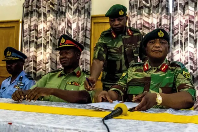 General Constantino Chiwenga Commander of the Zimbabwe Defence Forces (R) and Valerio Sibanda Commander of the Zimbabwe National Army (2L) address a media conference held at the Zimbabwean Army Headquarters on November 13, 2017 in Harare