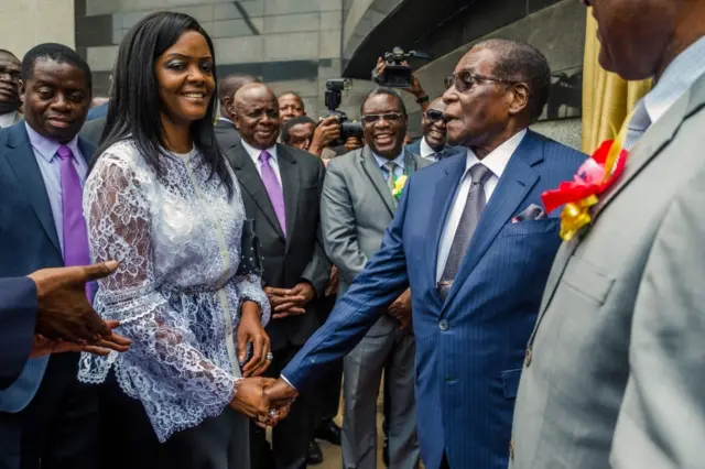 Robert Mugabe (R) is congratulated by First Lady Grace Mugabe after he unveiled a plaque at the country"s main international airport in Harare, Zimbabwe, renamed after him on November 9, 2017