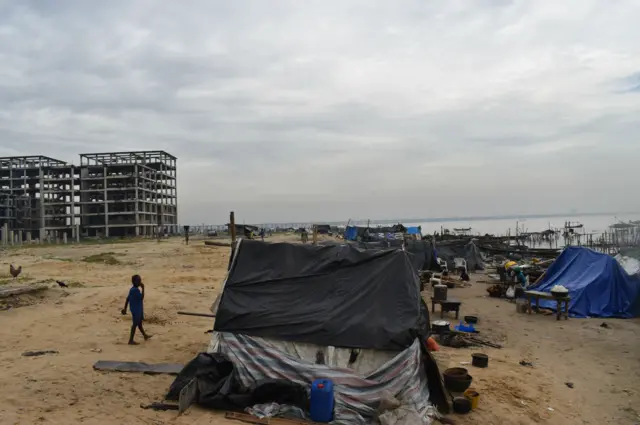 A section of Ilubirin community, with the ongoing government construction project in the background. The government is developing this area into luxury real estate.