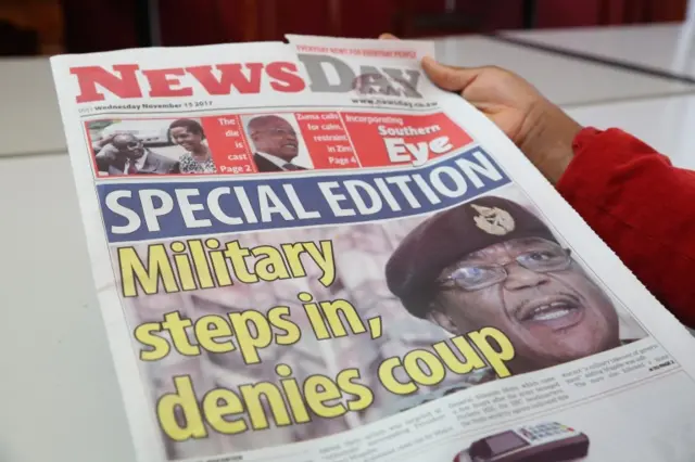 A woman reads a copy of the special edition of a local daily in Harare, Zimbabwe, 15 November 2017