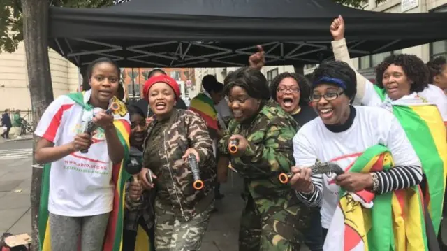 Zimbabwean exiles celebrate outside the embassy in London