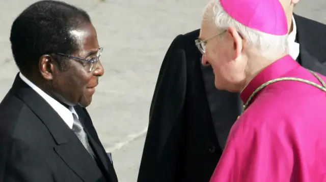 shop James Harvey (R) welcomes President Robert Mugabe of Zimbabwe (L) before the funeral of Pope John Paul II in St Peter's Square at the Vatican City 08 April 2005