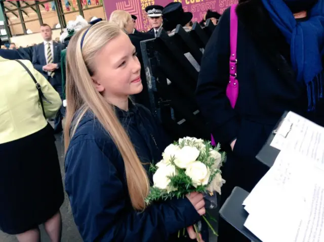 Girl with flowers for the Queen.