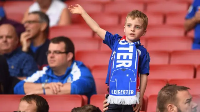 Little boy Leicester City fan waving