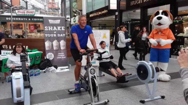 Humberside Fire and Rescue workers on cycling and rowing machines.