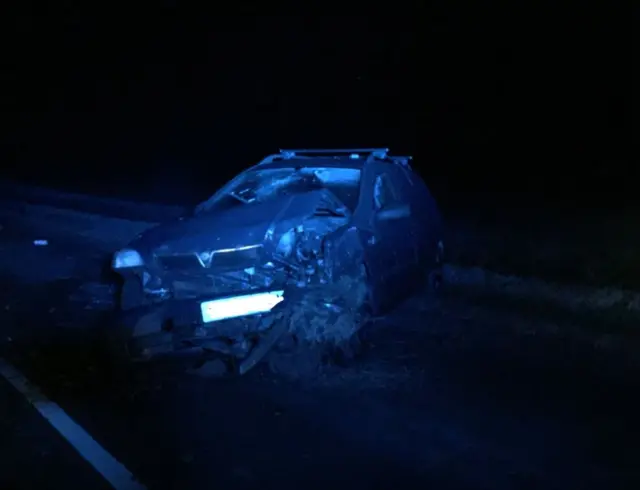 A crashed car with damage to its bonnet