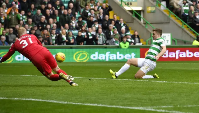 James Forrest slides in the first of his brace against Ross County at Celtic Park