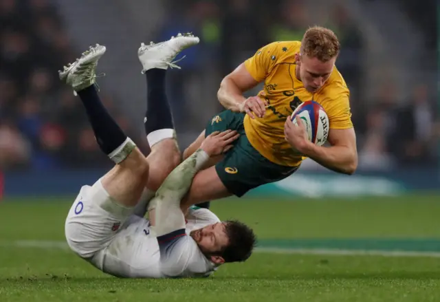 Reece Hodge is tackled by Elliot Daly