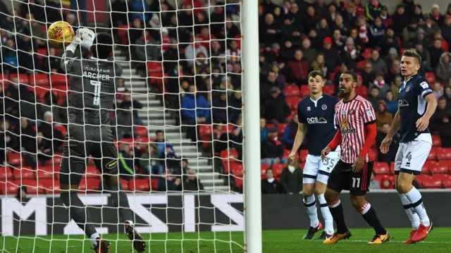 Jordan Archer of Millwall (left) spills the ball into his own net from an Adam Matthews cross