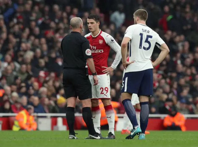 Arsenal's Granit Xhaka is shown a yellow card