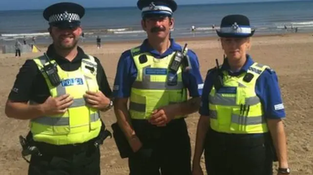 Police officers on beach