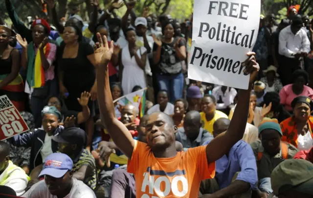 People gather at a opposition party rally outside the state parliament in preparation of the proposed impeachment of president Robert Mugabe, Harare, Zimbabwe, 21 November 2017.