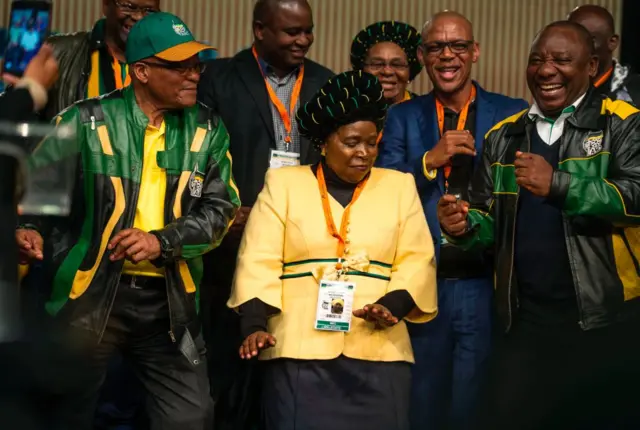 South African President Jacob Zuma (L), former African Union Chairperson and presidential hopeful Nkosazana Dlamini-Zuma (C) and South African Deputy President Cyril Ramaphosa (R) dance after the closing session of the South African ruling party African National Congress (ANC) policy conference on July 5, 2017 in Johannesburg, South Africa