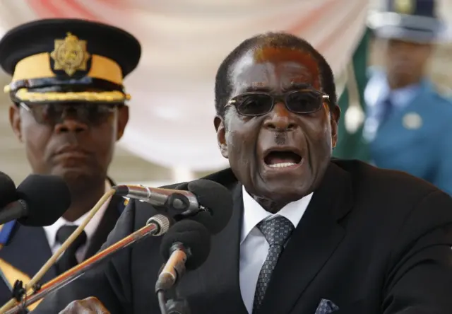 This file photo taken on January 18, 2010 shows Zimbabwean President Robert Mugabe giving a speech during the burial of Sunny Ntombiyelanga Takawira, wife of the late vice president of the Zimbabwe African National Union, Leopold Takawira, in Harare at the National Heroes Acre. Robert Mugabe resigned as president of Zimbabwe on November 21, 2017