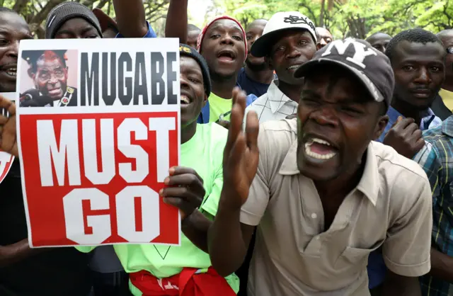 Protesters call for Zimbabwean President Robert Mugabe to resign across the road from parliament in Harare, Zimbabwe, November 21, 2017.