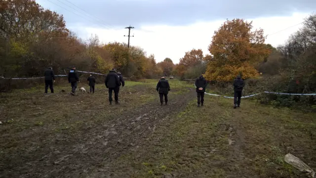 Police search with dogs on land in Bentley