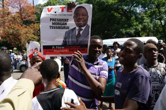 A protestor holds a portrait of Zimbabwean opposition and Movement for Democratic Change (MDC) leader Morgan Tsvangirai outside the Zimbabwean parliament on November 21, 2017 in Harare.