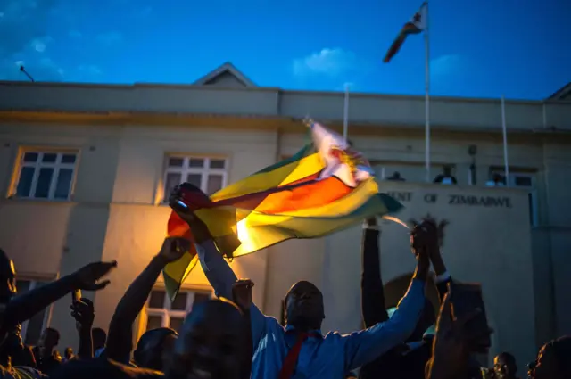 Harare residents celebrate in the streets after the resignation of Zimbabwe"s president Robert Mugabe on November 21, 2017 in Harare.